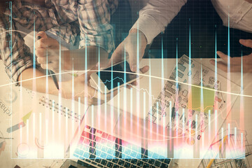 Double exposure of forex graph drawing and man and woman working together holding and using a mobile device. Trade concept.