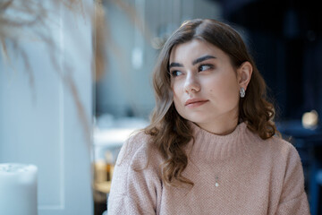 Romantic casual woman portrait. Woman at a cafe, sad alone girl.
