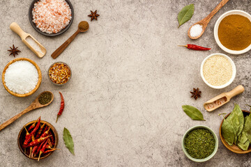 Fototapeta na wymiar Colorful herbs and spices in bowls for cooking. Pepper chili, laurel leaf, salt and curry
