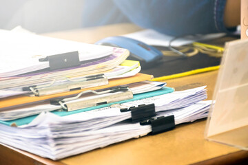 Unfinished Paper works on table of the secretary in the office, blurred background, soft and selective focus.