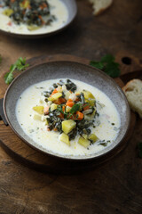 Creamy vegetable soup with wild herbs