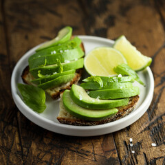 Homemade avocado toast with fresh lime