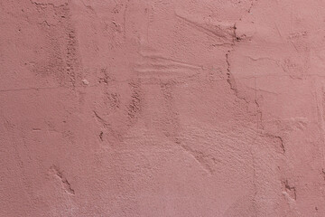 Texture of cracked concrete painted with pink paint with cracks and bumps. Wallpaper, Background. Close-up.
