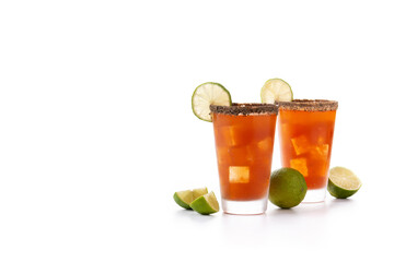 Homemade michelada cocktail with beer, lime juice,hot sauce,salted Rim and tomato juice isolated on white background. Copy space