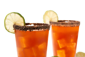 Homemade michelada cocktail with beer, lime juice,hot sauce,salted Rim and tomato juice isolated on white background