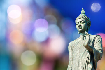 Buddha statue on bokeh nature background.