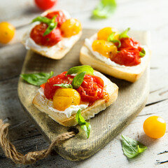 Tomato crostini with cream cheese and fresh basil	
