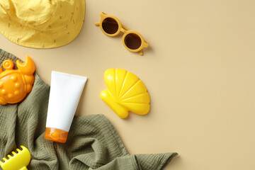 Flat lay sun protection cream for babies and toddlers with towel, kids sunglasses, panama hat,...
