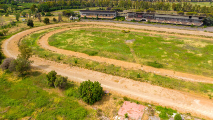Aerial view of the hippodrome of Tor di Valle in Rome, Italy. This stadium was an important horse racing venue and included a racetrack, a training track and right track. Now it's closed and abandoned