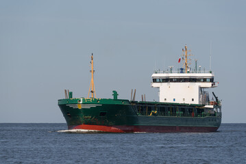 Fototapeta premium MARITIME TRANSPORT - A ship with a load is sailing on the sea
