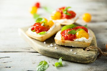 Tomato crostini with cream cheese and fresh basil	