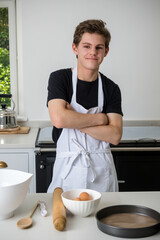 A Teenage Boy Cooking In A Kitchen