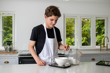 A Teenage Boy Cooking In A Kitchen