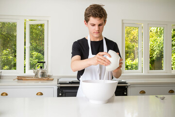 A Teenage Boy Cooking In A Kitchen