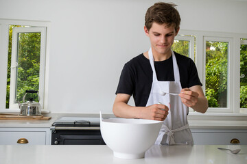 A Teenage Boy Cooking In A Kitchen