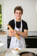 A Teenage Boy Cooking In A Kitchen