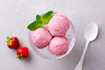 Strawberry Ice Cream in a glass bowl on grey background. Close up. Top view.