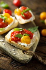 Tomato crostini with cream cheese and fresh basil	