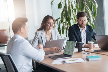 Obraz premium Corporate business team and manager in a meeting room at modern office with panoramic windows.