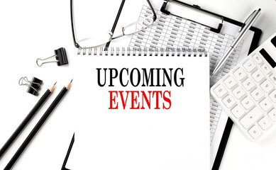 UPCOMING EVENTS word on notepad with clipboard , chart and calculator, business concept
