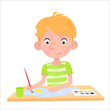 A boy with blond hair sits at a table and draws with a brush and paints