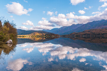 Autumn landscape by the lake Bohinj in Julian Alps. Fascinating reflectins in the lake on a cloudy...