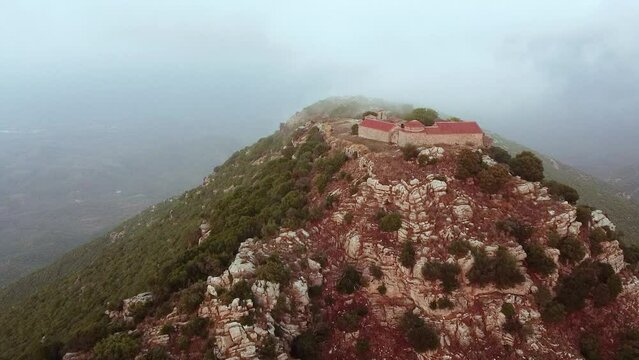 Aerial view of Voulcanos Monastery in Messinia region through rainy clouds