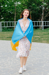 patriotic photo of a Ukrainian woman with the flag of Ukraine