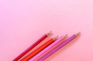 Pink pencils with copy space on pink  background 