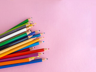 Colorful pencils with copy space on pink  background 