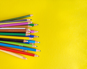 Yellow pencils with copy space on yellow background 