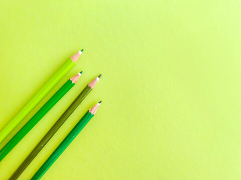 Green pencils with copy space on green background 