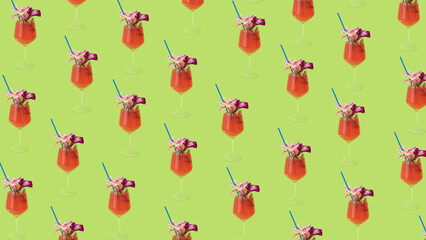 Summer creative pattern with cocktail glasses, drinking straw, and flowers on a pastel green...