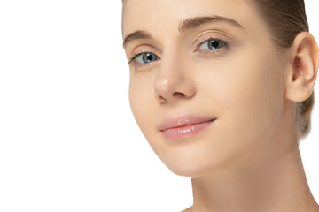 Fototapeta premium Close-up portrait of young beautiful woman with clean skin looking at camera isolated over white studio background. Cosmetology concept