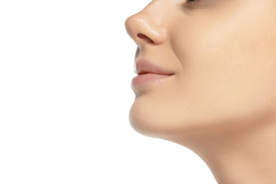 Cropped side view image of female chin, nose and cheeks isolated over white studio background. Lifting
