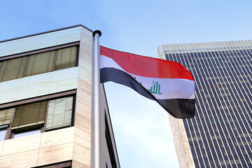 silk national flag of Algeria on facade building of Consulate General of iraq in Frankfurt, concept of emigration, international relations, tourist visa processing, economy, politics, independence day