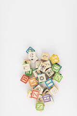 A pile of children painted alphabet wooden blocks isolated with white background for text copy space. 