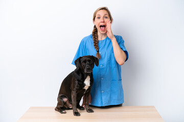Young veterinarian woman with dog isolated on white background shouting with mouth wide open