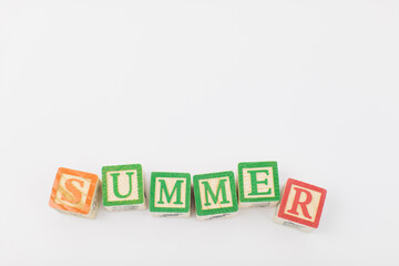 An arrangement of children painted alphabet wooden blocks spelling out 