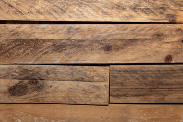 Varnished wooden planks with l nails and saw marks