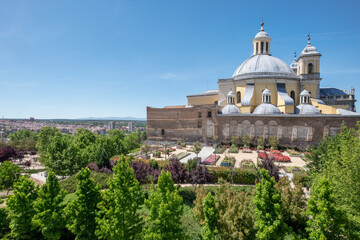 Fototapeta na wymiar Side view of gardens and Royal Basilica of San Francisco El Grande in Madrid