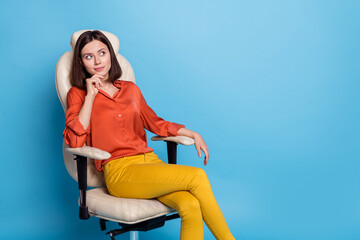 Portrait of attractive minded confident girl sitting in armchair thinking copy blank space isolated...