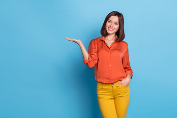 Photo of young pretty lady promoter present product offer select advert discount isolated over blue color background