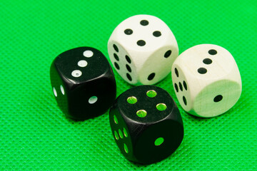 Black and white dice on green ground