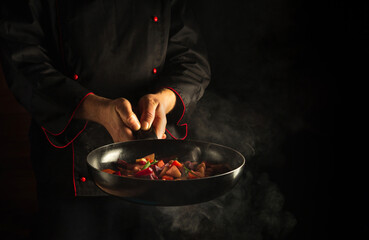 Chef holding a hot frying pan with steam. Asian food idea for a hotel with advertising space