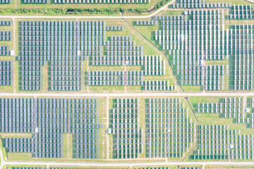 Solar farm, field or solar power plant in aerial view consist of photovoltaic cell in panel,...