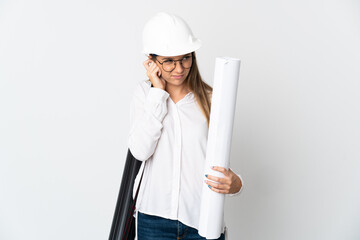 Young Lithuanian architect woman with helmet and holding blueprints isolated on white background frustrated and covering ears