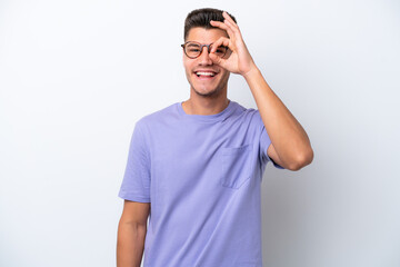 Fototapeta premium Young caucasian man isolated on white background showing ok sign with fingers