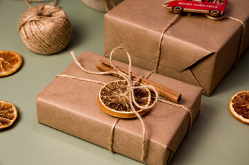 Christmas zero waste concept. Eco friendly packaging gifts in craft paper decorated with dry...