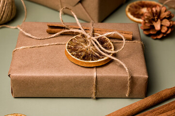 Christmas zero waste concept. Eco friendly packaging gifts in craft paper decorated with dry...